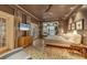 This main bedroom has hardwood floors, water views, and a large television at 4311 Bay Shore Rd, Sarasota, FL 34234