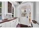 Well-lit mud room features custom cabinets, sink, terracotta tile floor, and convenient outdoor access at 4311 Bay Shore Rd, Sarasota, FL 34234