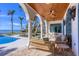 Charming outdoor living space with comfortable seating, pool, and scenic waterfront views at 4311 Bay Shore Rd, Sarasota, FL 34234