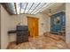 Outdoor patio with an outdoor kitchen, tile flooring, and translucent roof at 4311 Bay Shore Rd, Sarasota, FL 34234