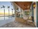 Covered patio with comfortable seating, ceiling fans, and scenic views of the pool and waterfront at 4311 Bay Shore Rd, Sarasota, FL 34234