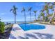 Beautiful pool area with well-manicured landscaping and stunning waterfront views at 4311 Bay Shore Rd, Sarasota, FL 34234