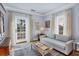 This sitting area has a plush sofa and coffee table overlooking the balcony at 4311 Bay Shore Rd, Sarasota, FL 34234