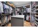 A very large walk-in closet has shelves and hanging space for clothing and shoes at 4311 Bay Shore Rd, Sarasota, FL 34234