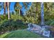 Backyard garden path with stone lion statues and lush landscaping at 4311 Bay Shore Rd, Sarasota, FL 34234