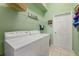 Bright laundry room, washer, dryer, and ample storage at 4423 Via Del Villetti Dr, Venice, FL 34293