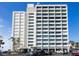 Condo building exterior showcasing architectural details and parking at 4822 Ocean Blvd # 8B, Sarasota, FL 34242