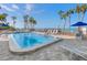 Inviting community pool with ocean views and ample lounge chairs at 4822 Ocean Blvd # 8B, Sarasota, FL 34242