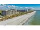 Aerial view of beachfront property, highlighting expansive beach and buildings at 565 Sanctuary Dr # A203, Longboat Key, FL 34228