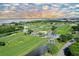 Aerial view of lush golf course and waterfront at 565 Sanctuary Dr # A203, Longboat Key, FL 34228