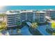 Stunning beachfront condo building with pool and lush landscaping at 565 Sanctuary Dr # A203, Longboat Key, FL 34228
