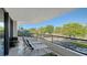 Relaxing balcony with lounge chairs and tranquil views of the landscape at 565 Sanctuary Dr # A203, Longboat Key, FL 34228