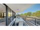 Large balcony with outdoor dining furniture at 565 Sanctuary Dr # A203, Longboat Key, FL 34228