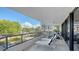 Spacious balcony with lounge chairs and outdoor furniture, offering scenic views at 565 Sanctuary Dr # A203, Longboat Key, FL 34228