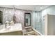 Modern bathroom with double sinks, patterned wallpaper and a large walk-in shower at 565 Sanctuary Dr # A203, Longboat Key, FL 34228