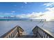 Steps leading to pristine beach with lounge chairs at 565 Sanctuary Dr # A203, Longboat Key, FL 34228