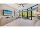 Luxurious bedroom with a king-size bed and large windows offering scenic views at 565 Sanctuary Dr # A203, Longboat Key, FL 34228