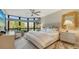 Spacious bedroom with large windows, a comfy sitting area, and a king-size bed at 565 Sanctuary Dr # A203, Longboat Key, FL 34228