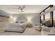 Spacious bedroom with ocean views and a ceiling fan at 565 Sanctuary Dr # A203, Longboat Key, FL 34228