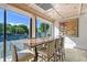 Community room with large table and chairs, overlooking tennis courts at 565 Sanctuary Dr # A203, Longboat Key, FL 34228