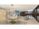 Elegant dining room with glass table and modern chandelier at 565 Sanctuary Dr # A203, Longboat Key, FL 34228