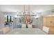 Bright dining area with a large, modern chandelier at 565 Sanctuary Dr # A203, Longboat Key, FL 34228