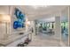 Condo entryway featuring large art piece and view to living area at 565 Sanctuary Dr # A203, Longboat Key, FL 34228