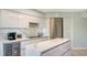 Modern kitchen with white cabinetry and marble countertops at 565 Sanctuary Dr # A203, Longboat Key, FL 34228