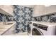 Modern laundry room with stylish wallpaper at 565 Sanctuary Dr # A203, Longboat Key, FL 34228