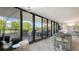 Living room with access to a spacious balcony and water view at 565 Sanctuary Dr # A203, Longboat Key, FL 34228