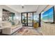 Living room with comfortable seating and balcony access at 565 Sanctuary Dr # A203, Longboat Key, FL 34228