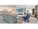 Bright living room with fireplace, large TV, and comfortable seating at 565 Sanctuary Dr # A203, Longboat Key, FL 34228