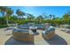 Circular outdoor seating area with fire pit, perfect for relaxing at 565 Sanctuary Dr # A203, Longboat Key, FL 34228