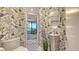 Stylish powder room with patterned wallpaper and a modern vessel sink at 565 Sanctuary Dr # A203, Longboat Key, FL 34228