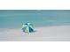 Blue and green umbrella on a sandy beach at 639 Cornwell On The Gulf, Venice, FL 34285