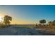 Stunning sunrise over the ocean with palm trees and beach access at 639 Cornwell On The Gulf, Venice, FL 34285