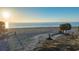 Aerial view of a pristine beach at sunrise, showcasing the property's beachfront location at 639 Cornwell On The Gulf, Venice, FL 34285
