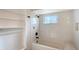 Bathroom features a shower/tub combo, tiled walls, and glass shelving at 640 Venice Ln, Sarasota, FL 34242