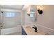 Elegant bathroom with a soaking tub, updated vanity, and tiled walls at 640 Venice Ln, Sarasota, FL 34242