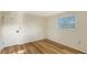 Bright bedroom with wood-look flooring and a door at 640 Venice Ln, Sarasota, FL 34242