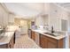 Eat-in kitchen with updated cabinetry and flooring at 640 Venice Ln, Sarasota, FL 34242