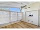 Bright sunroom with hardwood floors and ceiling fan at 640 Venice Ln, Sarasota, FL 34242