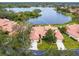 Aerial view of villa with lake access and lush landscaping at 7323 Oak Moss Dr # 42, Sarasota, FL 34241