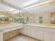 Spacious bathroom with double vanity, large mirror, and updated fixtures at 7323 Oak Moss Dr # 42, Sarasota, FL 34241