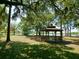 Quaint gazebo nestled under shady trees in a lush green park-like setting at 7323 Oak Moss Dr # 42, Sarasota, FL 34241