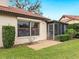 Exterior view of house with a screened porch and manicured lawn at 7323 Oak Moss Dr # 42, Sarasota, FL 34241