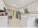 Well-equipped kitchen with white cabinets and tile floor at 7323 Oak Moss Dr # 42, Sarasota, FL 34241