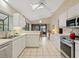Bright kitchen with access to a screened-in porch at 7323 Oak Moss Dr # 42, Sarasota, FL 34241