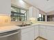 Kitchen featuring a double sink and white cabinets at 7323 Oak Moss Dr # 42, Sarasota, FL 34241