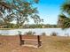 Peaceful lakeside bench offers scenic views of tranquil waters and community homes at 7323 Oak Moss Dr # 42, Sarasota, FL 34241